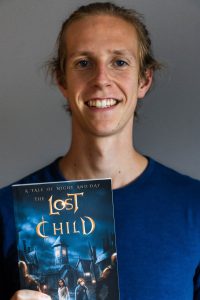 Andrew Clegg holding a copy of his book The Lost Child