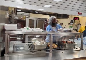 Student serving lunch at mission