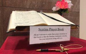 Scecina Prayer Book on stand with vase of flowers